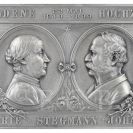 Stegmann Johann: jednostranná cínová plaketa vydaná u příležitosti zlaté svatby Marie a Johanna Stegmannových s medailony manželů, 1899; Nebe s.r.o.