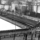 Tělovýchovná zařízení: původní zimní stadion s umělou ledovou plochou a dřevěnými tribunami postavený roku 1946, stav po požáru v únoru 1957, sbírka J. Dvořáka; SOkA.